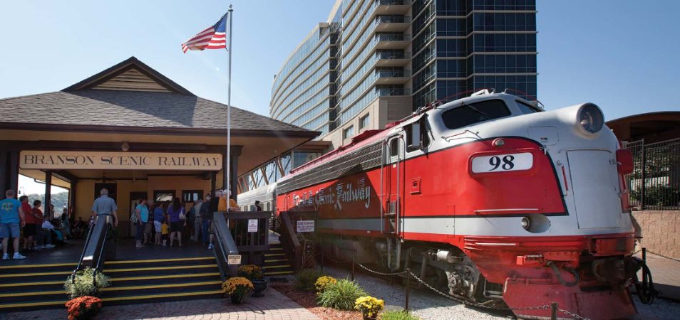 A train sitting at a station on the Branson Scenic Railway.