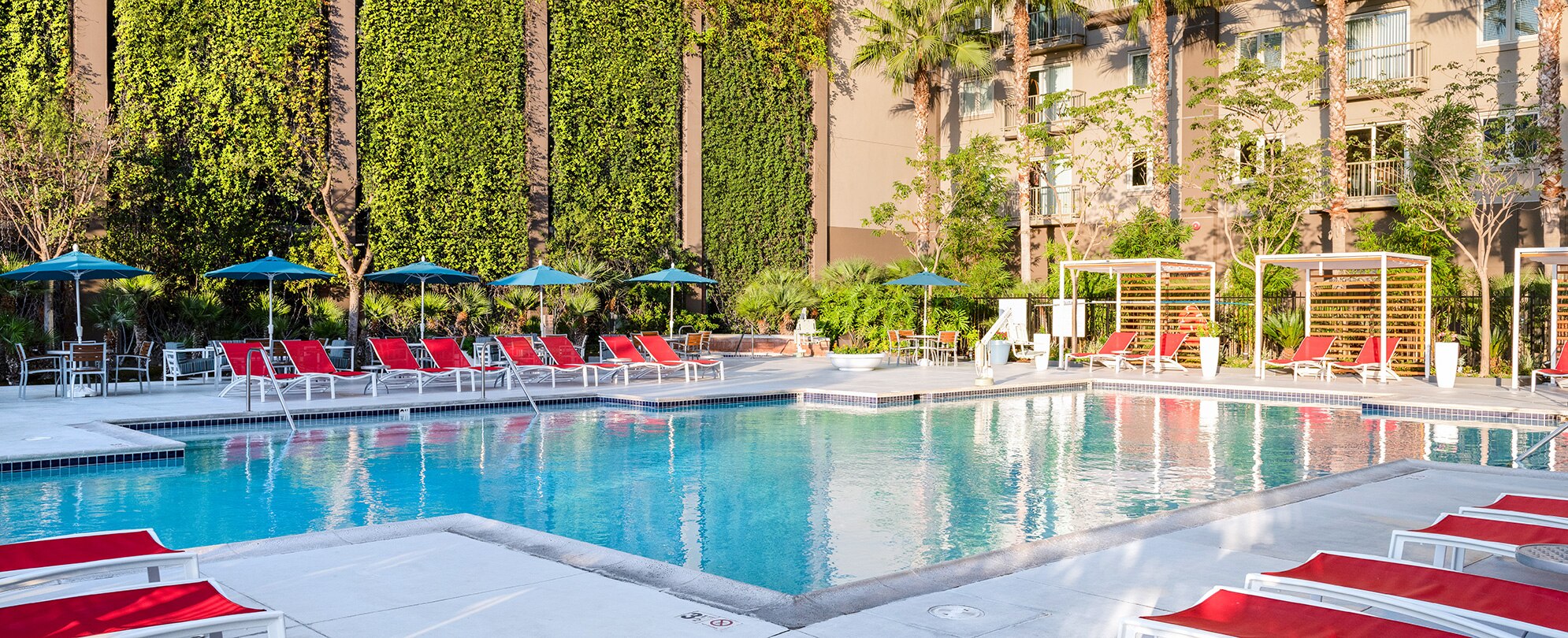 An outdoor pool surrounded by lounge chairs at WorldMark /Club Wyndham Anaheim, a timeshare resort in California.