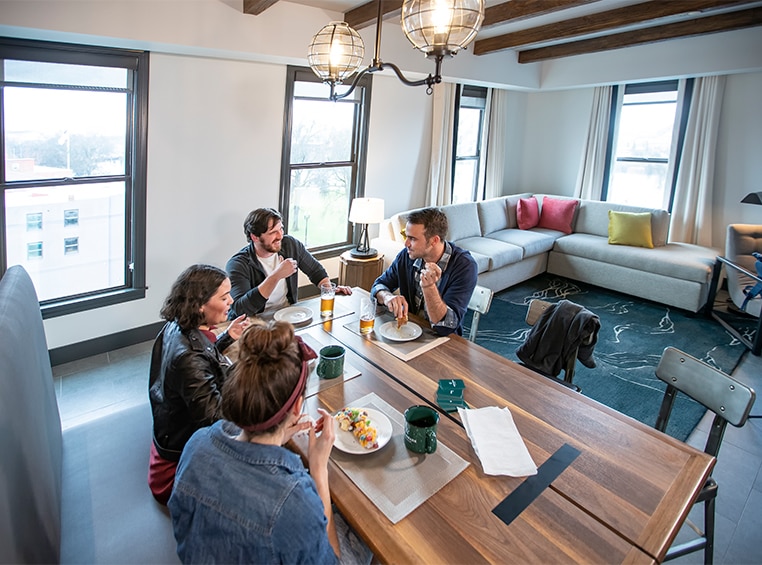 Friends enjoying a meal at their suite dining table at a WorldMark resort.