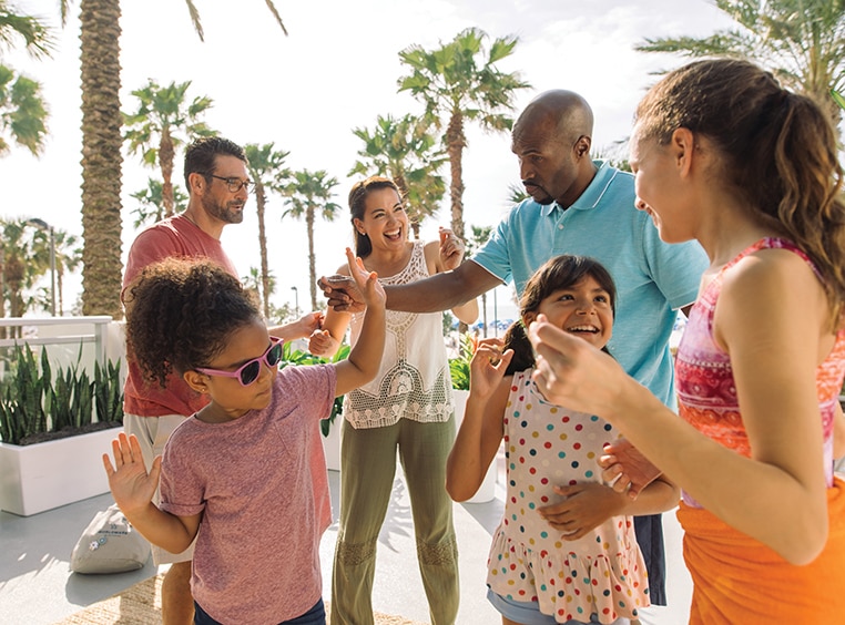 A family of six is gathered together, having a good time on vacation.